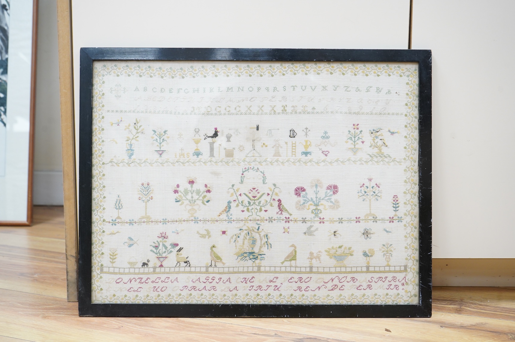 An unusual Ligurian Italian finely embroidered 19th century sampler. Worked with a verse below of row of the alphabet and three rows of motifs of birds flowers and animals. The verse written in the Ligurian regional dial